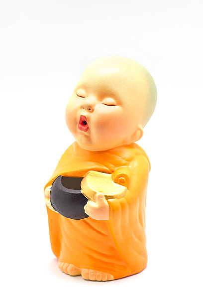 istock Earthenware of child monk isolated on white background 488031273