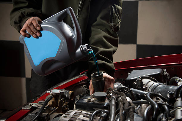 Antifreeze, Coolant Auto repairman pouring antifreeze into radiator dump radiator stock pictures, royalty-free photos & images