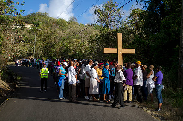Monchy Gros Islet, St Lucia - April 18, 2014: Roman Catholic faithfuls wend their way through the community of Monchy on Good Friday as they reenact the journey of Christ to Cakvary on the day of his crucifixion.