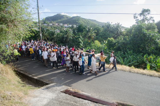 Monchy Gros Islet,  St Lucia - April 18, 2014: Roman Catholic faithfuls wend their way through the community of Monchy on Good Friday as they reenact the journey of Christ to Cakvary on the day of his crucifixion