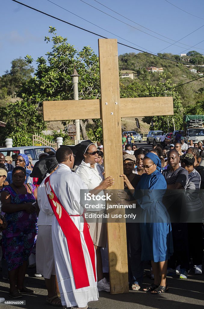 Good Friday procession ceremony Monchy Gros Islet, St Lucia - April 18, 2014: Roman Catholic faithfuls pause for prayer holding up a crucifix to represent the death of Jesus as they re-enact His journey to Calvary on the day of His crucifixion. Catholicism Stock Photo