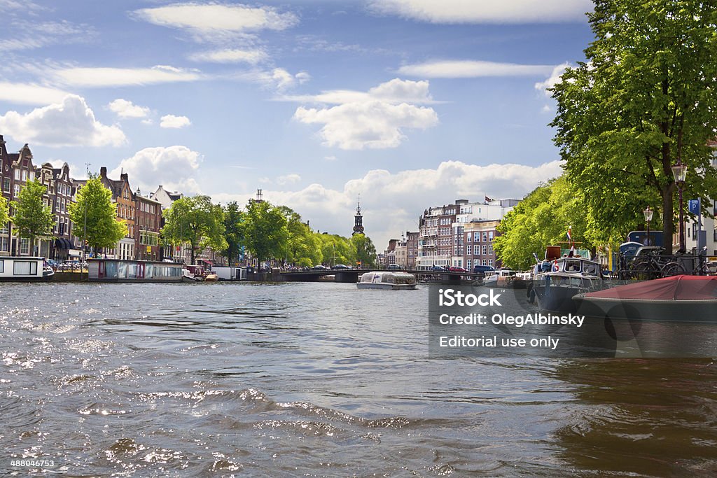 Amstel River, Amsterdam. Amsterdam, The Netherlands - July 2, 2012: The Amstel River in Historic Center of Amsterdam on a beautiful summer day. Amstel River Stock Photo