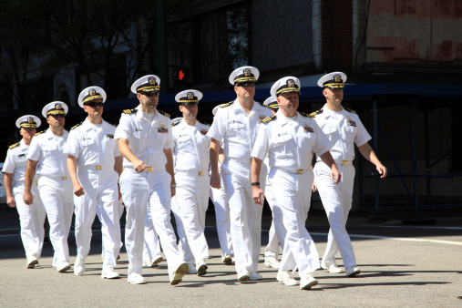 Norfolk, Va. USA - April 26, 2014: On a sunny Saturday morning during the NATO parade in downtown Norfolk, Virginia a group of Navel Officers participate in a march through the parade route.