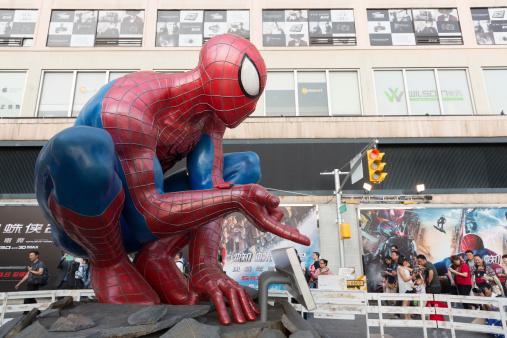 Hong Kong, Hong Kong SAR - April 17, 2014: People walk past the Harbour City in Tsim Sha Tsui, Kowloon, Hong Kong. The Amazing Spider-Man 2 promotion is outside the Harbour City shopping mall.