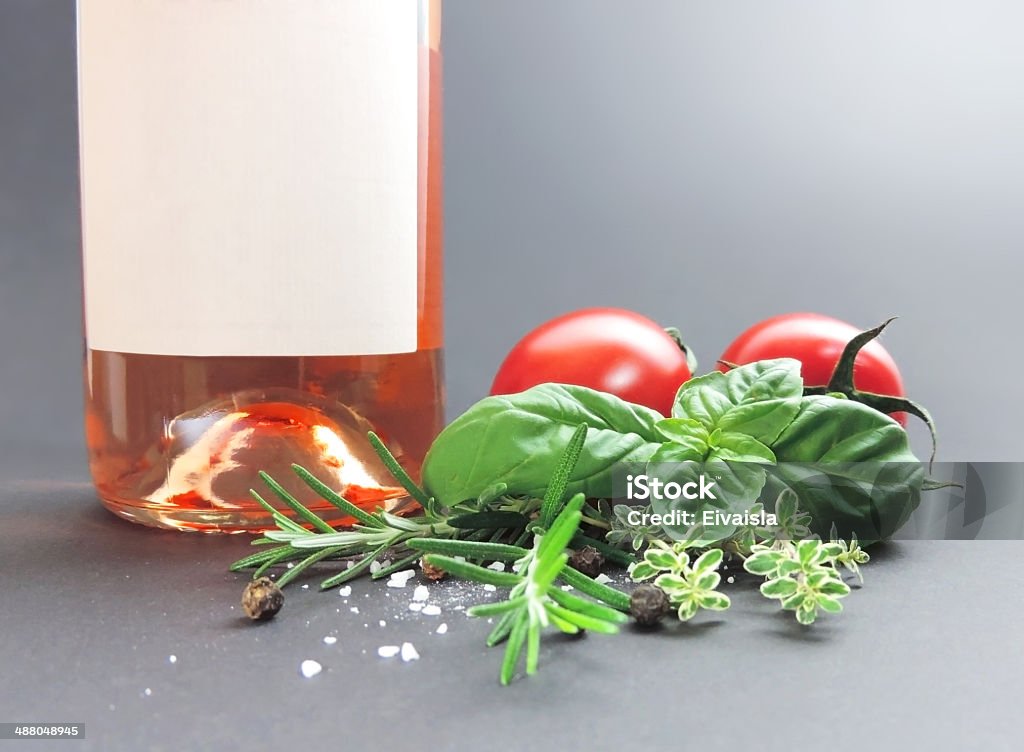 Wine and ingredients Rosé wine with decorative herb bouquet, studio shot.   Basil Stock Photo