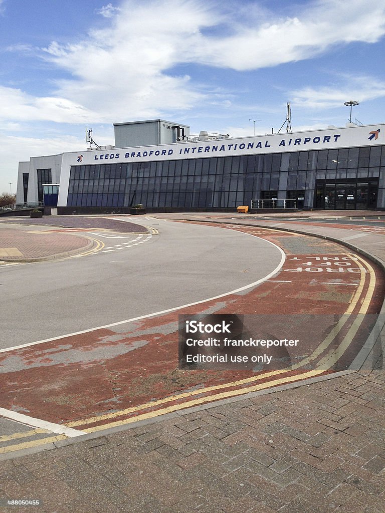 Leeds Bradford international airport Yeadon, UK - April 16, 2014: External view of the Leeds Bradford international airport on the West Yorkshire. This airport is situated in Yeadon on the metropolitan area of Leeds, it's an Hub for Ryanair, Transavia and Jet2. Image taken in the afternoon on a cloudy day. Airport Stock Photo