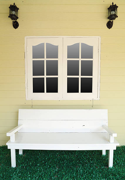 istock wooden bench for rest under the window 488051179