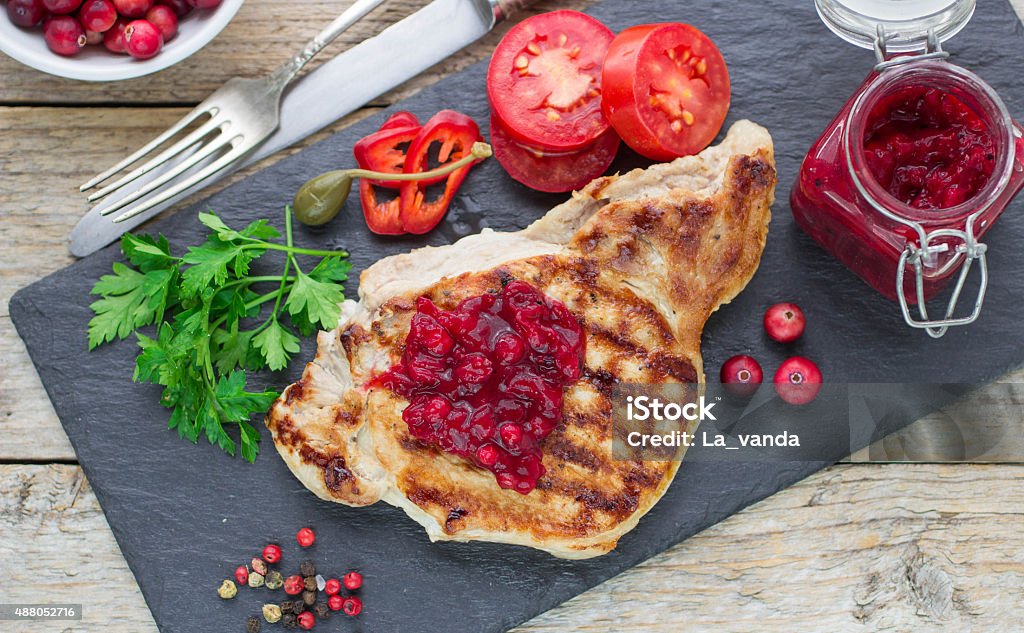 Grilled meat with cranberry sauce Grilled meat with cranberry sauce. Selective focus 2015 Stock Photo