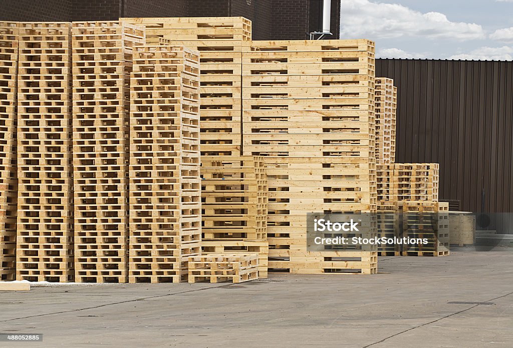 Wooden Pallet stack Stock Piles of wooden pallets in a yard ready for breaking up and recycling into firewood or kindling. Wood - Material Stock Photo