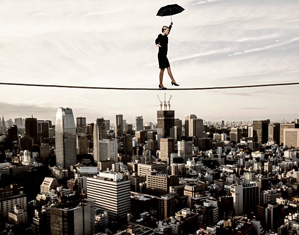 istock Businesswoman walking on tightrope 488053383