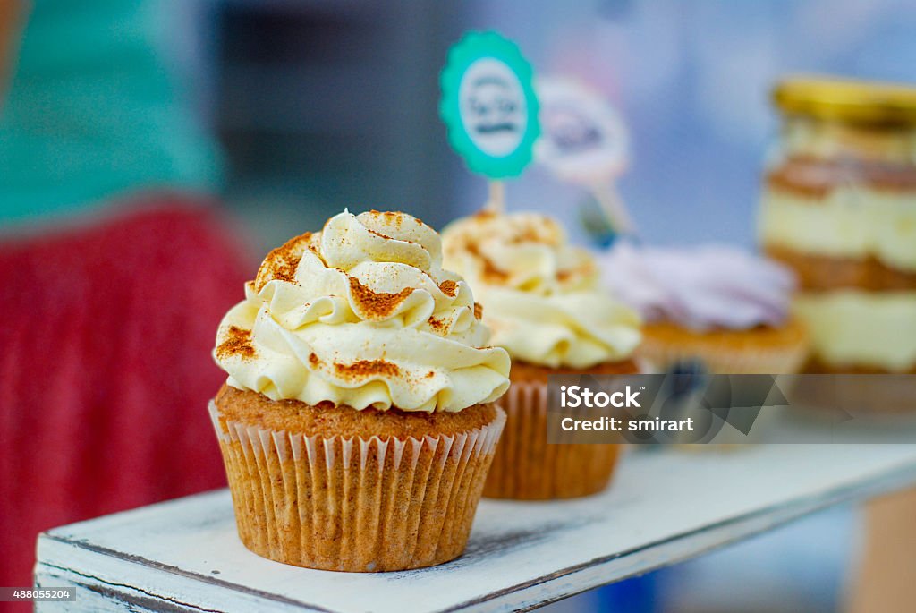 cupcakes with cream and berries cupcakes and cakes on a shelf in a cafe 2015 Stock Photo