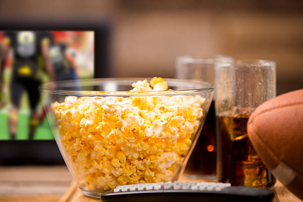 istock Watching football game on television at pub or home. Popcorn. 488056840