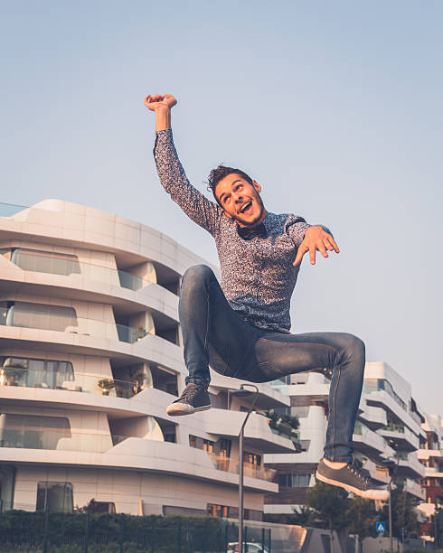 istock Young handsome man jumping in the city streets 488057446