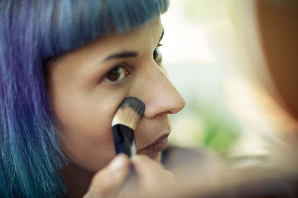 istock Beautiful girl applying make-up 488057498