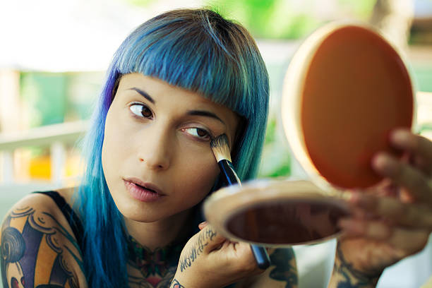 istock Beautiful girl applying make-up 488057598