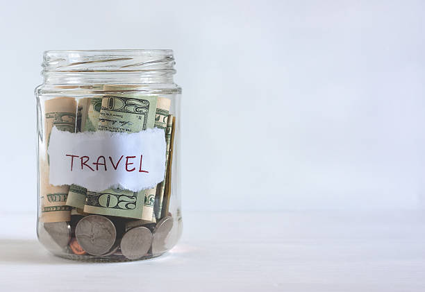istock Jar filled with US coins and dollar bills 488058742