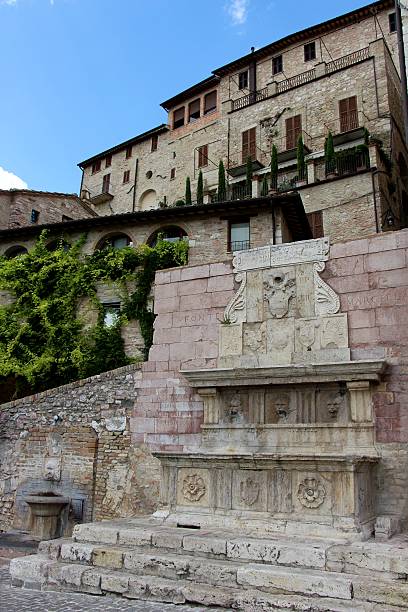istock assisi - fountain in the old town 488061704