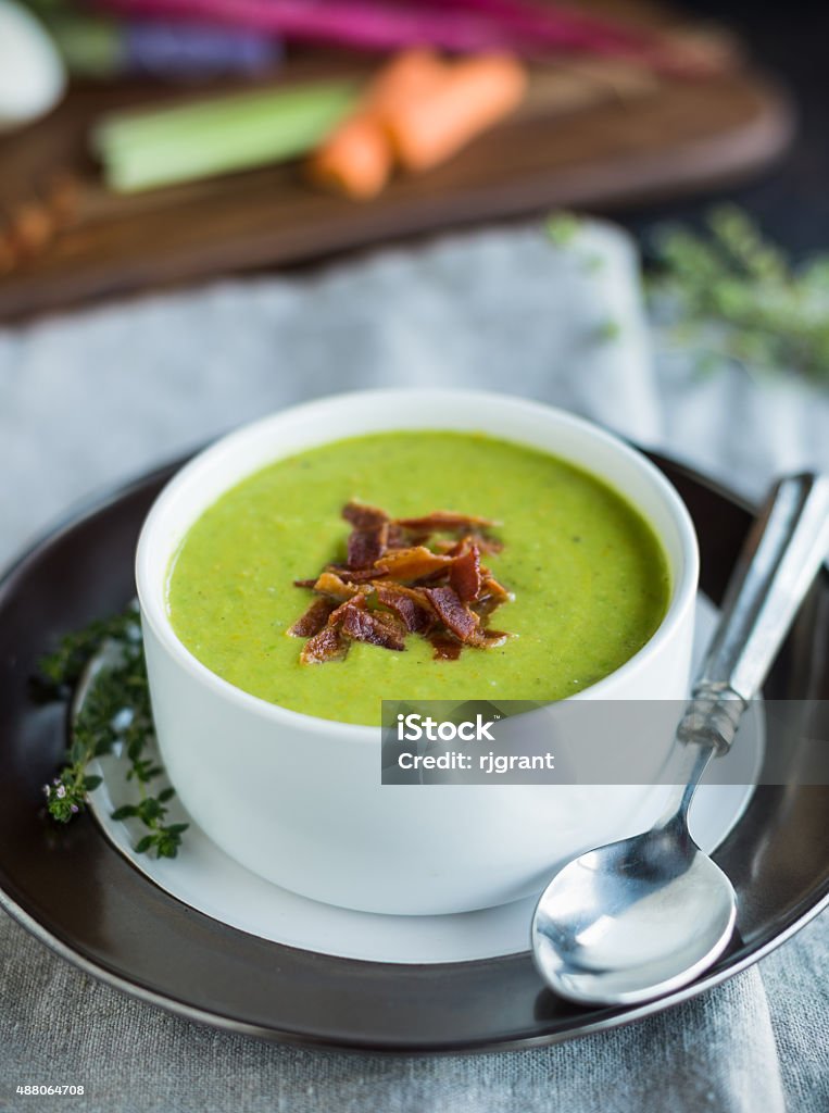 Split Pea Soup Bright green pureed pea soup with bacon garnish 2015 Stock Photo
