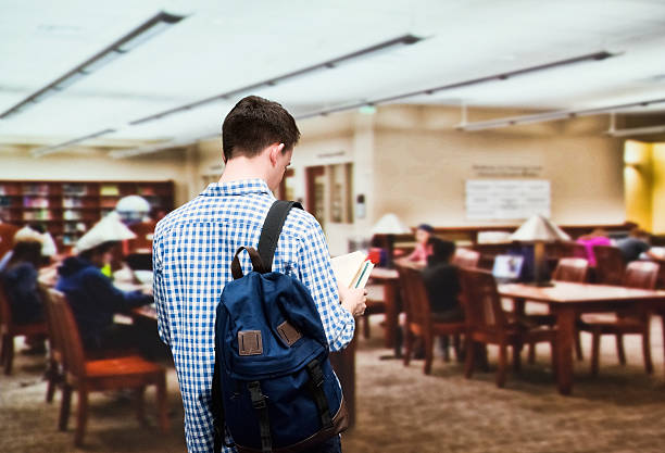 Rear view of student in library
