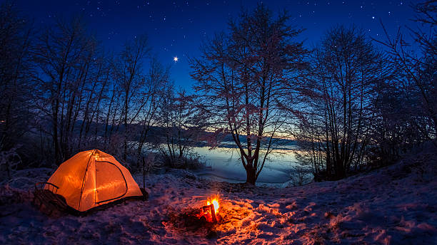 istock Illuminated tent in the winter camp by the lake 488065814