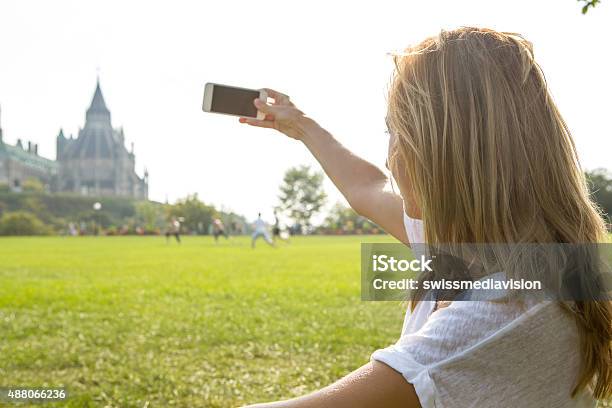 Young Woman In Ottawa Photographing Parliament Using Mobile Phone Stock Photo - Download Image Now