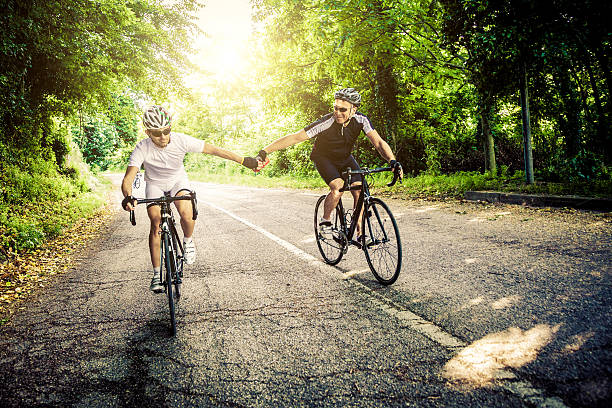 istock Cyclist riding, passing water bottle 488076293