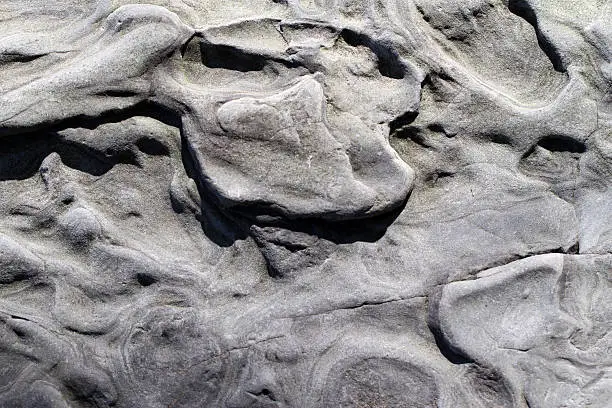 The sea erodes stone in strange patterns.