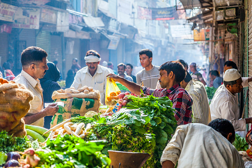 Delhi, India - October 16, 2012: Cman sells vegetables at Chawri Bazaar. Chawri Bazar is a specialized wholesale market of food and vegetables in Delhi, India. Established in 1840 it was the first wholesale market of Old Delhi.