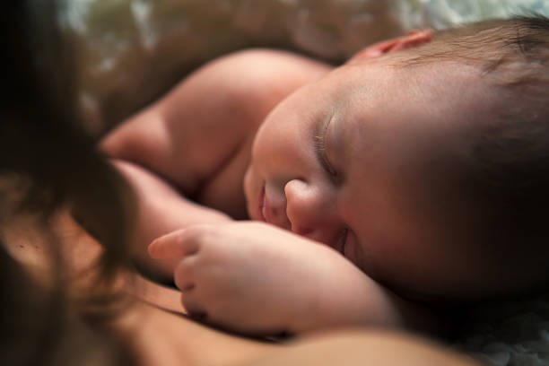 istock adorable baby sleeping on stomach 488078525