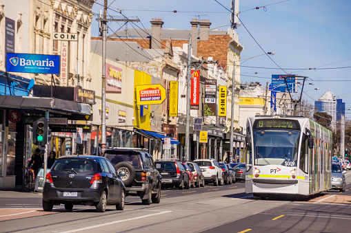 Melbourne, Australia - September 11, 2015: Tram 19 passes Barkly Square Shopping Centre and various shops on Sydney Road, Brunswick.