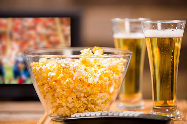 istock Watching football game on television at pub or home. Popcorn. 488080608