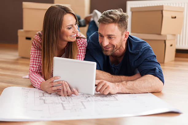 istock Couple arranging new apartment with digital tablet 488081589