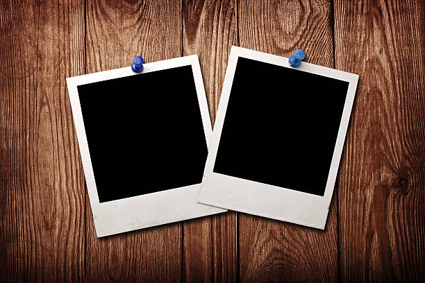 istock old photos on a wooden background 488081665