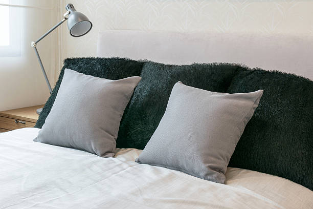 istock bedroom interior design with grey pillows on white bed 488083870