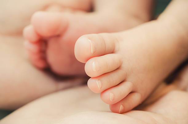istock Baby's foot in mother hands 488085848