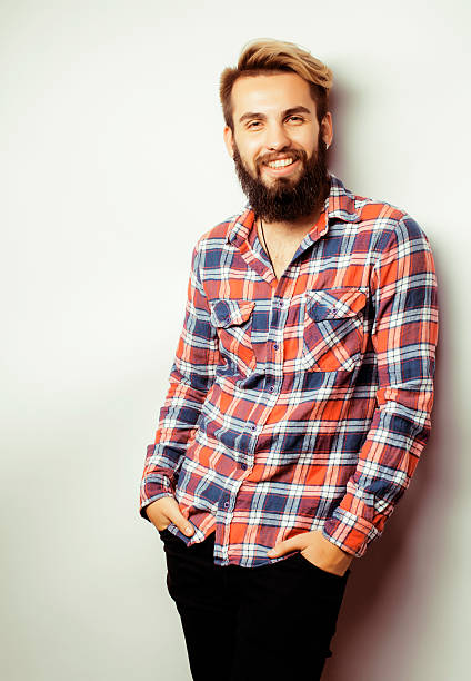 istock portrait of young bearded hipster guy smiling on white background 488094812