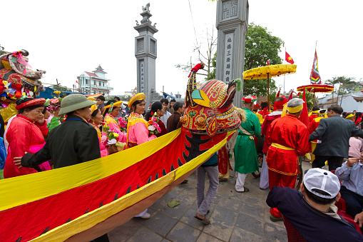 Namdinh, Vietnam - April 14, 2013: One group of people and mascots are dancing in traditional festivals in Nam Dinh, Vietnam