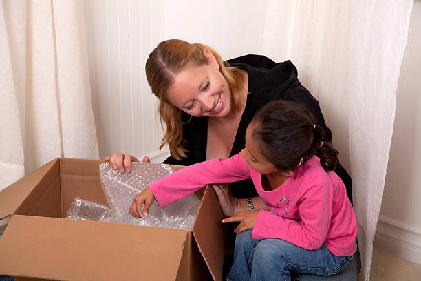 istock Mother and daughter unpacking in a new home 488096889
