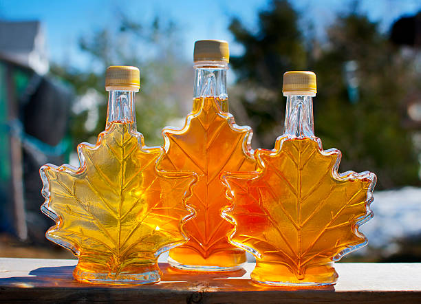 Pure Nova Scotia Maple Syrup Three bottles of maple syrup made by a backyard hobbyist in Nova Scotia. maple syrup stock pictures, royalty-free photos & images