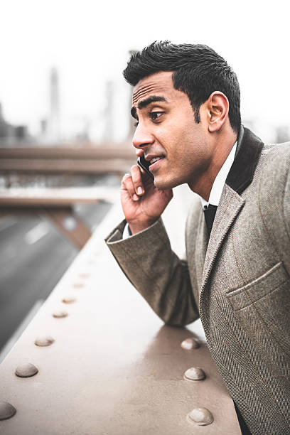 istock Businessman on the phone in brooklyn bridge 488103537