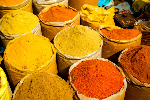 Sacks of different colorful spices at the Chadni Chowk spice market in Delhi, India 