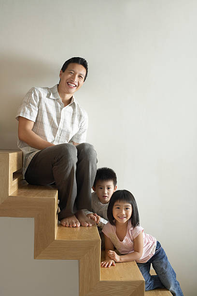 istock Father Sitting With Kids On Wooden Steps 488104345