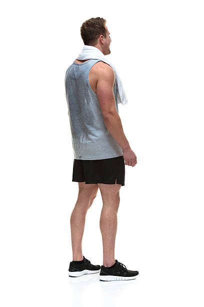 istock Rear view of man standing with towel 488104373