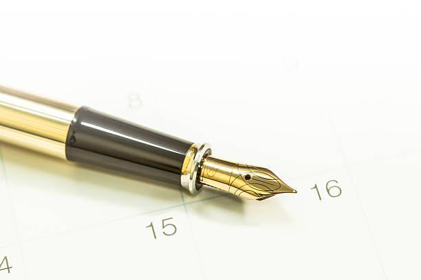 istock Gold fountain pen on calendar 488106584