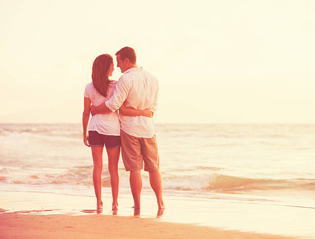 istock Romantic Couple Enjoying Beautiful Sunset at the Beach 488106676