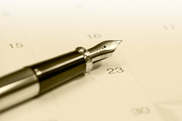 istock Gold fountain pen on calendar 488106932