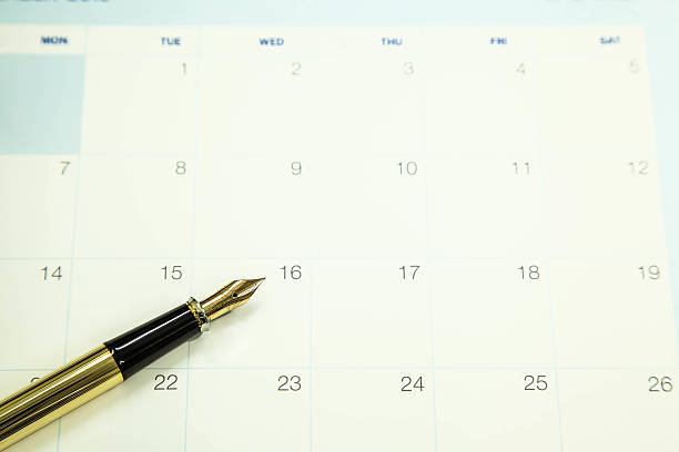 istock Gold fountain pen on calendar 488107124