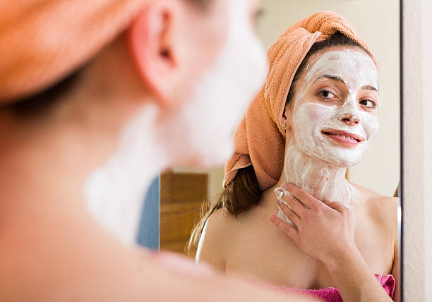 istock Girl applying cream on skin 488107354