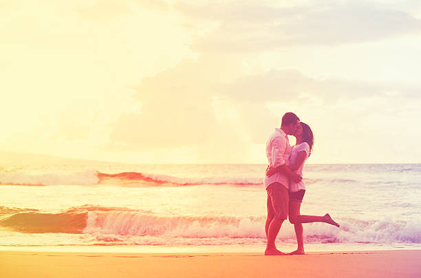 istock Romantic Couple Kissing on the Beach at Sunset 488107594