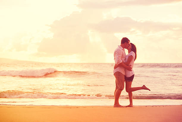 istock Romantic Couple Kissing on the Beach at Sunset 488107800